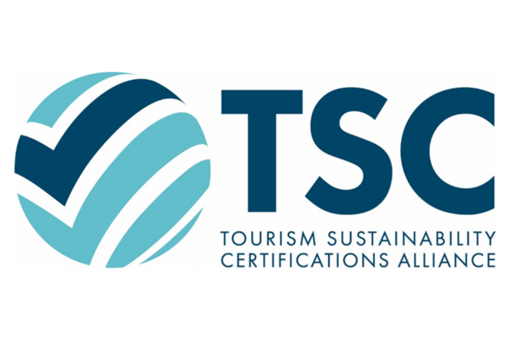 On the left, there is a round logo resembling a turquoise sphere with a dark blue checkmark. On the right, the letters "TSC" appear, with the description "Tourism Sustainability Certifications Alliance" written below in dark blue text.